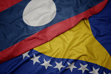 waving colorful flag of bosnia and herzegovina and national flag of laos.