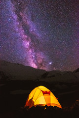 Pamir Lenin Peak Kyrgyzstan Yellow tent on a background of lilac starry sky