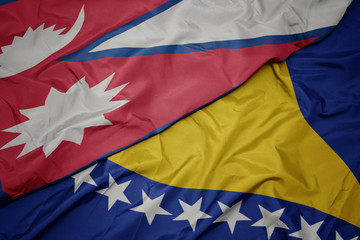 waving colorful flag of bosnia and herzegovina and national flag of nepal.