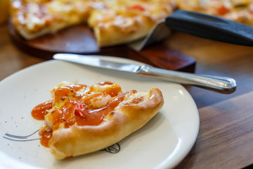 Seafood Italian Pizza slice on wood dish