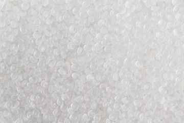 Raw plastic material white granules, close up