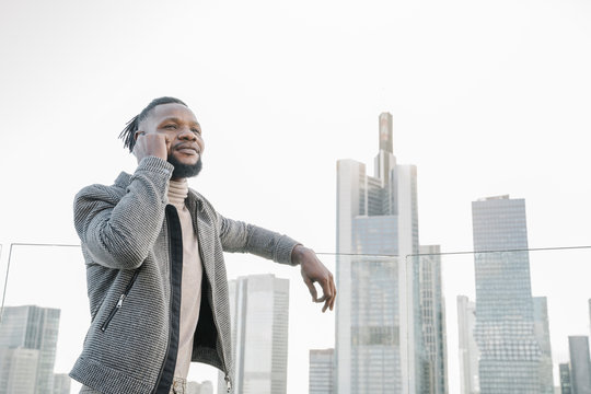 Stylish man on the phone on observation terrace with skycraper view, Frankfurt, Germany