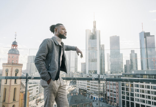 Stylish man on observation terrace looking at skycraper view, Frankfurt, Germany