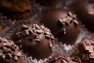 Mixed luxury dark and milk chocolate truffles. Assorted delicious handmade chocolate pralines in a row. Full frame background. Studio shot. Close-up