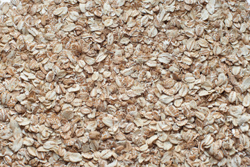 raw oat flakes on white background