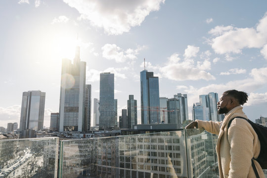 Stylish man on observation terrace looking at skycraper view, Frankfurt, Germany