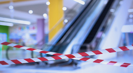 Hazard safety stripes across empty shopping mall elevator