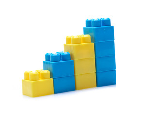 Obraz premium Colorful stacked toy plastic building blocks isolated on white background