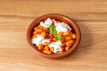 clay pot with gnocchi and burrata