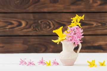 spring  flowers in vase on wooden background