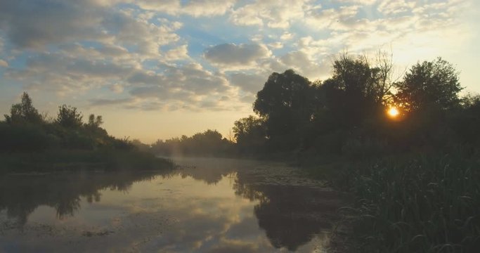 Beautiful dramatic foggy landscape. Fog over the peaceful morning surface of the river. Landscape of Ukraine in the early morning and sunrise.