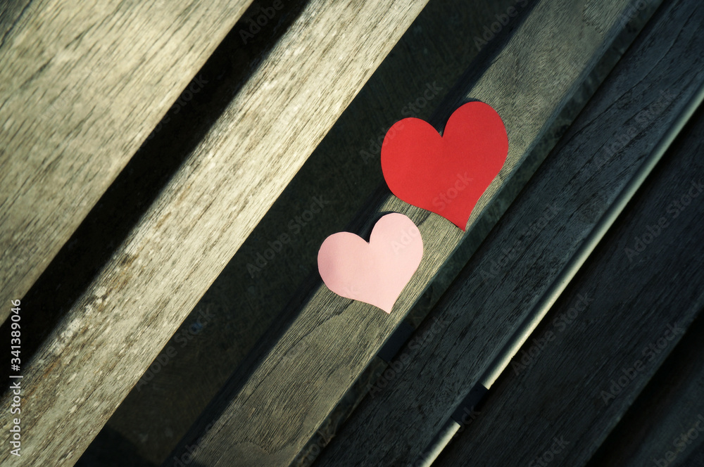 Wall mural close-up red and pink heart shape on wood