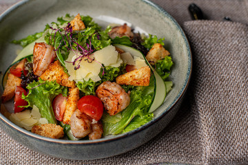 Fototapeta na wymiar salad with avocado and shrimps in bowl, top view, copy space