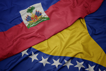 waving colorful flag of bosnia and herzegovina and national flag of haiti.