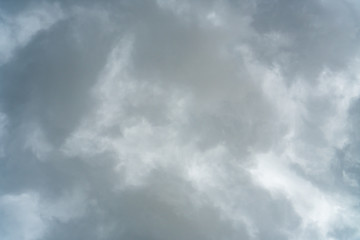 Background of beautiful dark clouds before a raining and thunder-storm. A dramatic sky with gray dense clouds. view from ground surface.sad feel.