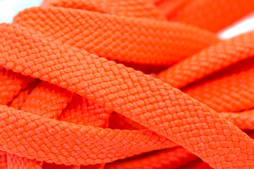 Orange shoelaces, isolated on a white background, close up