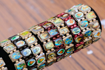 Fototapeta na wymiar Elasticated wooden bracelets with religious images