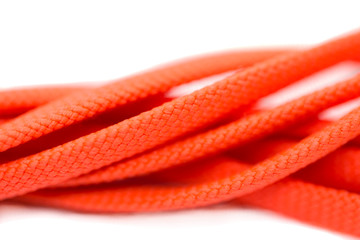 Orange shoelaces, isolated on a white background, macro