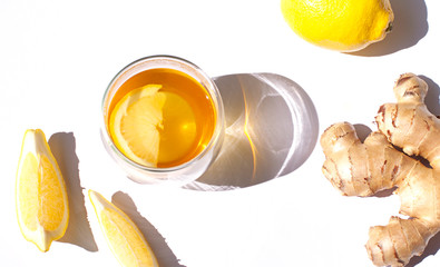 Fototapeta na wymiar Glass of green tea with lemon and ginger close up 