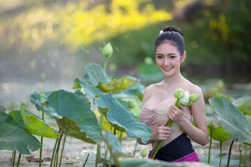 Fotobehang Lotusbloem Asian woman harvest lotus flower in the garden,  © warongdech