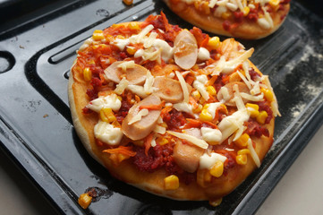 Mini Pizza with sausage, corn, carrot, cheese and Beef. Homemade mini pizza.                              