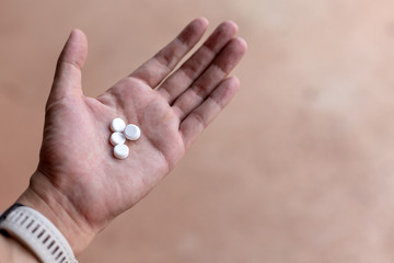 Woman holding pill in hands taking emergency medicine