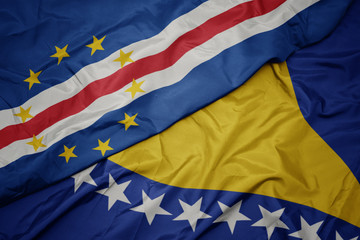 waving colorful flag of bosnia and herzegovina and national flag of cape verde.