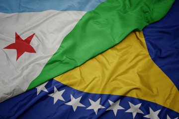 waving colorful flag of bosnia and herzegovina and national flag of djibouti.