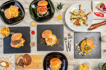 overhead shot of hamburgers with potato garnish