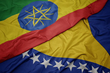 waving colorful flag of bosnia and herzegovina and national flag of ethiopia .