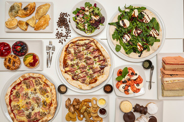 Image of table full of Italian pizzas
