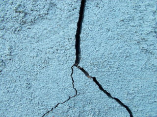 
Crack in the wall of the building. Blurred defocused background for web design.