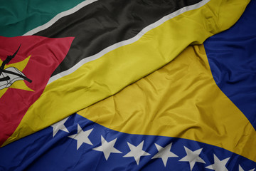 waving colorful flag of bosnia and herzegovina and national flag of mozambique.