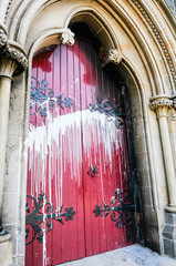 The door of a Roman Catholic Church suffers scorch damage from petrol bombs and paint during a sectarian attack