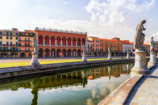 Prato della Valle square with canal statues and Loggia Amulea in Padua, Italy