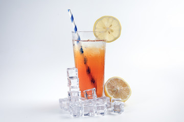 Ice lemon tea with ice cube yellow lemon slice blue white paper straw on white background