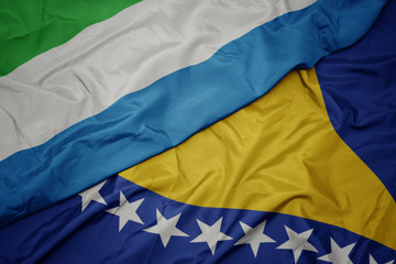 waving colorful flag of bosnia and herzegovina and national flag of sierra leone.