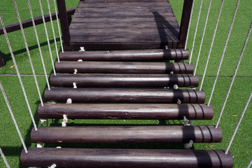 Playground wooden bridges with green grass