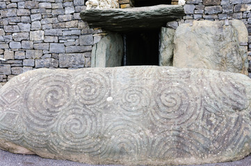 Spiral carvings on a kerb stone at the entrance to Newgrange chambered passage tomb