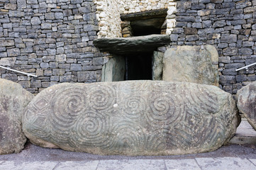 Spiral carvings on a kerb stone at the entrance to Newgrange chambered passage tomb