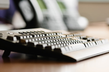 A computer keyboard on an office desk