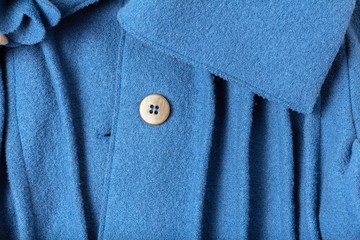 Blue wool texture coat with collar and button close up