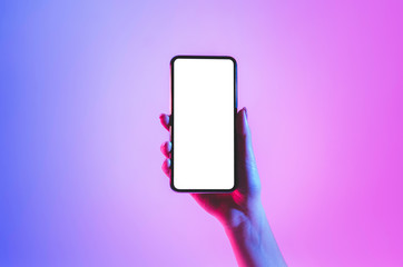 Blank screen smartphone in neon, close up