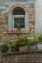 Details of  the windows and the brick walls of an ancient house, old town, Grado, Gorizia, Italy