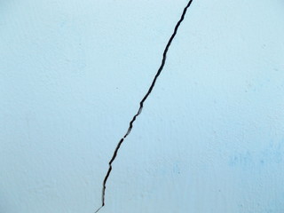 
Crack in the wall of the building. Blurred defocused background for web design.