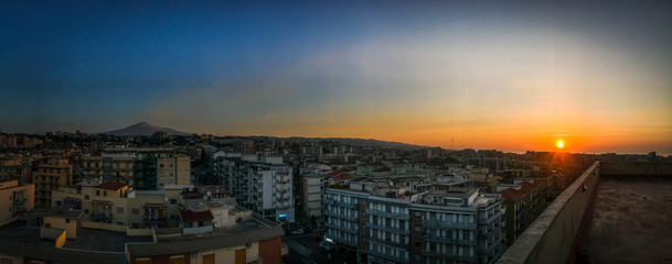 Sunrise over the city of Catania with the volcano Etna