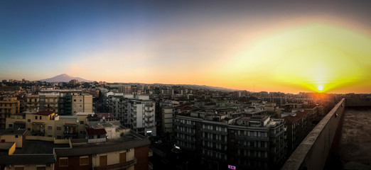 Sunrise over the city of Catania with the volcano Etna