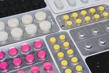 Many colorful tablets in a blister pack. The concept of the pharmaceutical industry. Pharmacy-Pharmacy.