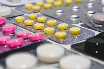 Many colorful tablets in a blister pack. The concept of the pharmaceutical industry. Pharmacy-Pharmacy.