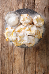 Soffioni Abruzzesi are cute little Italian cupcakes or muffins filled with fluffy Ricotta cream close-up on a slate board. Vertical top view